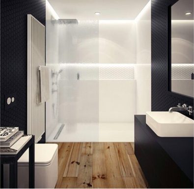 Baño moderno de lujo con ducha acristalada y detalles de interiorismo en tonos oscuros, diseñado por Suárez & Co. Interiorismo.